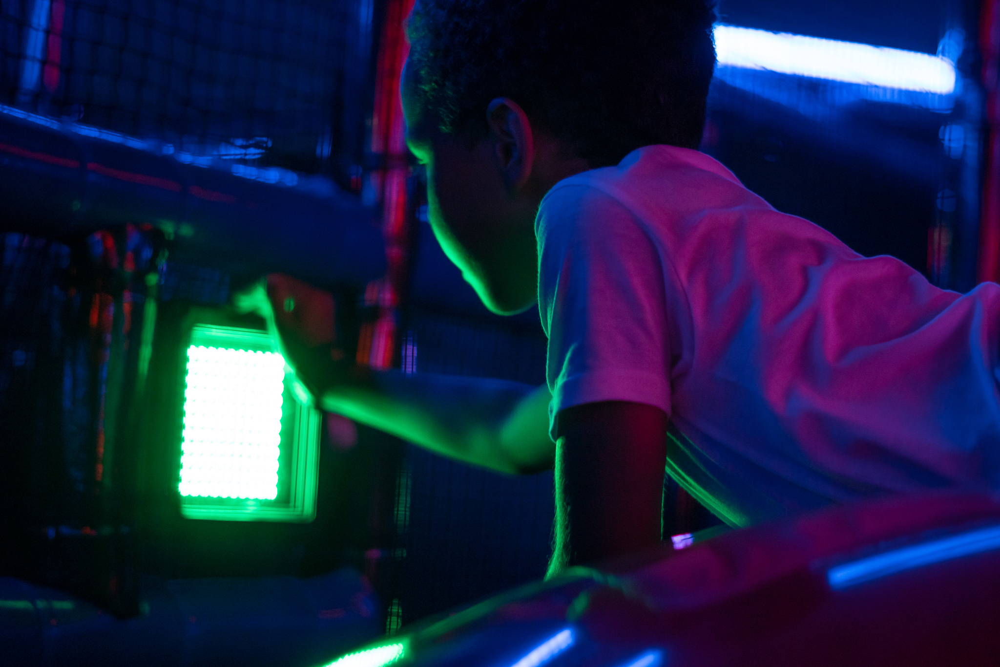 boy reaching for beacon at indoor play arena